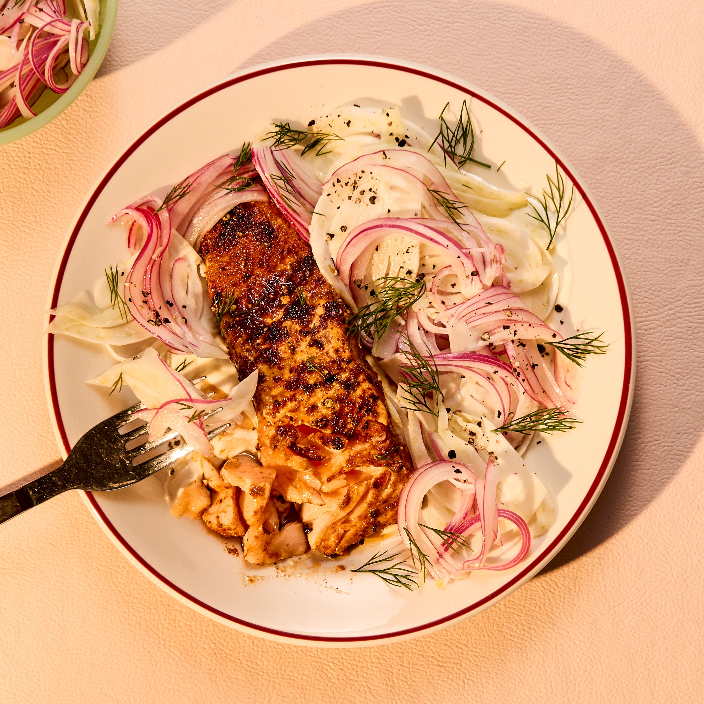 Salmon With Fennel Slaw on a white bowl on a white background